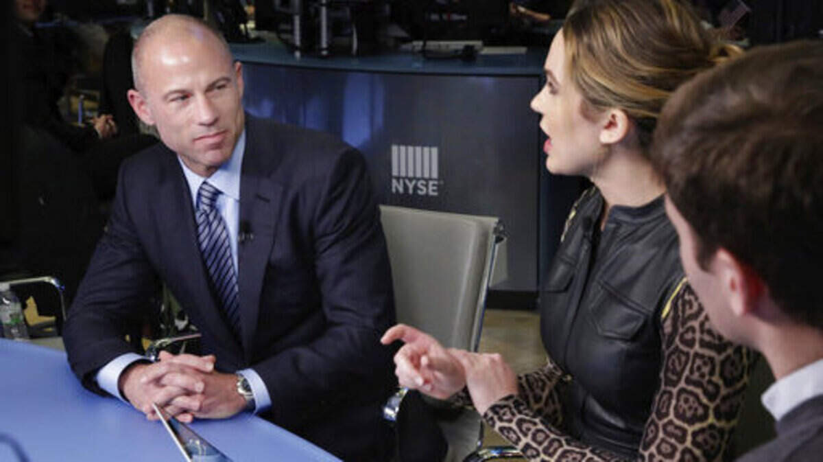 Michael Avenatti, lawyer for Stormy Daniels, left, is interviewed by host Kristen Scholer on Cheddar, on the floor of the New York Stock Exchange, Thursday, April 5, 2018.  Before Avenatti accused Donald Trump and his attorney of a payoff scheme to muzzle Stormy Daniels, he faced allegations of dubious business dealings as owner of flailing coffee chain Tully's.