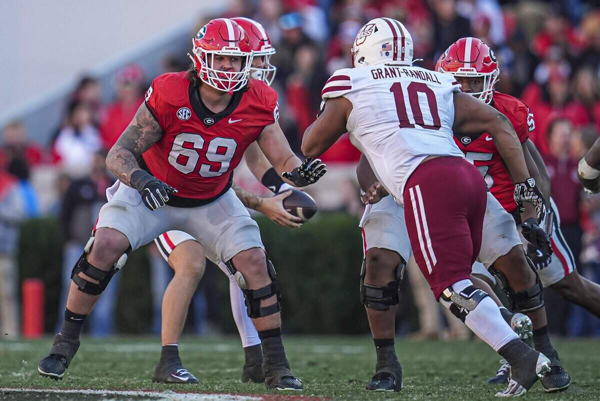 Nov 23, 2024; Athens, Georgia, USA; Georgia Bulldogs offensive lineman Tate Ratledge (69) blocks against Massachusetts Minutemen defensive end Zukudo Igwenagu (10) during the second half at Sanford Stadium. Mandatory Credit: Dale Zanine-Imagn Images