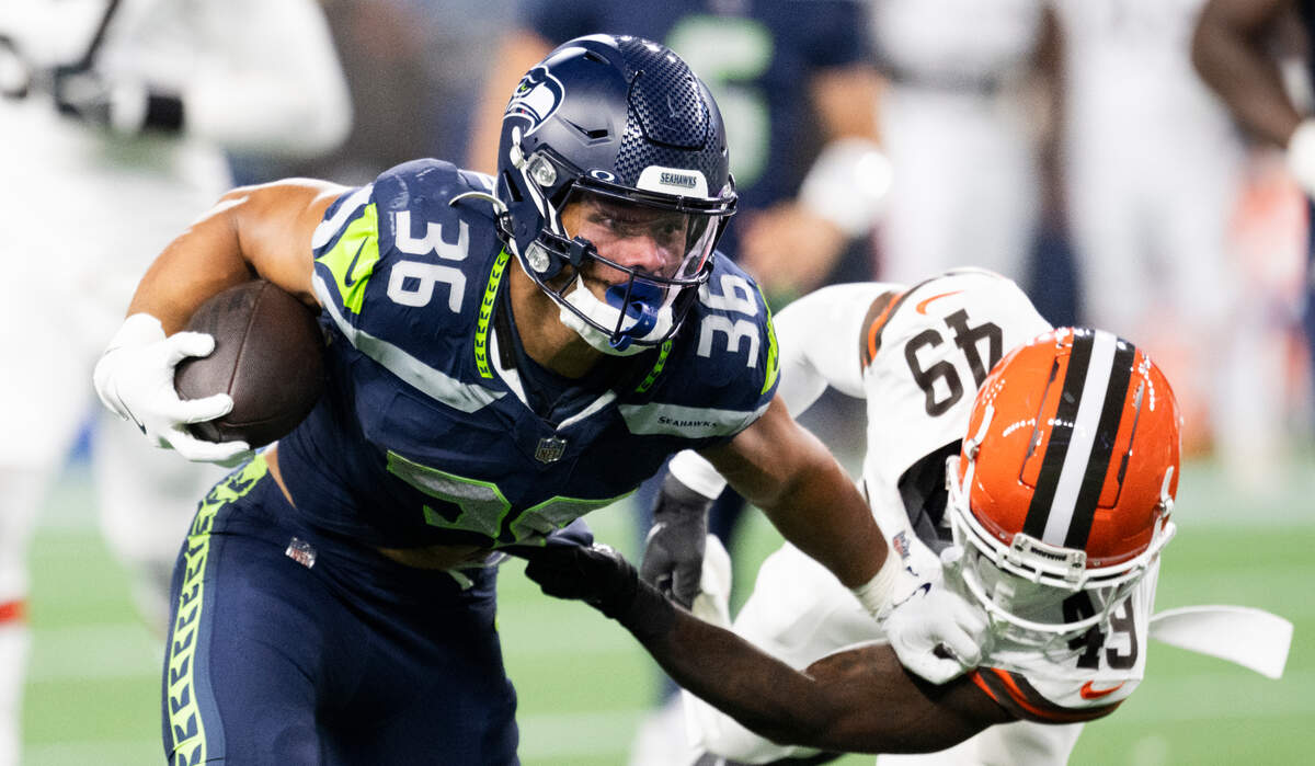 Seattle Seahawks running back George Holani (36) stiff arms Cleveland Browns cornerback Faion Hicks (49) on the carry during the third quarter of the preseason game at Lumen Field, on Saturday, Aug. 24, 2024 in Seattle, Wash.