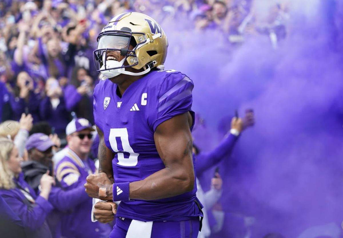 University of Washington quarterback Michael Penix emerges from a purple haze upon being introduced at Husky Stadium before the Huskies played Oregon Oct. 14, 2023.