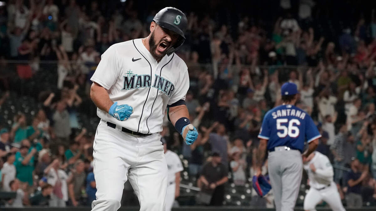 Seattle Mariners’ Luis Torrens, left, celebrates his single that scored Jarred Kelenic with the winning run off of Texas Rangers pitcher Dennis Santana (56) during the ninth inning of a baseball game Wednesday, Aug. 11, 2021, in Seattle. The Mariners won 2-1. (AP Photo/Ted S. Warren)
