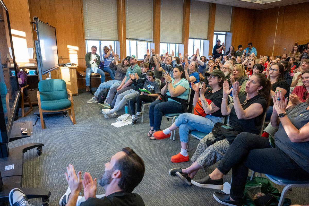 An overflow space is filled with people watching and reacting to public comments during a Tacoma Public Schools board of directors meeting on Thursday, May 22, 2025, at TPS Central Administration Building in Tacoma, Wash. 