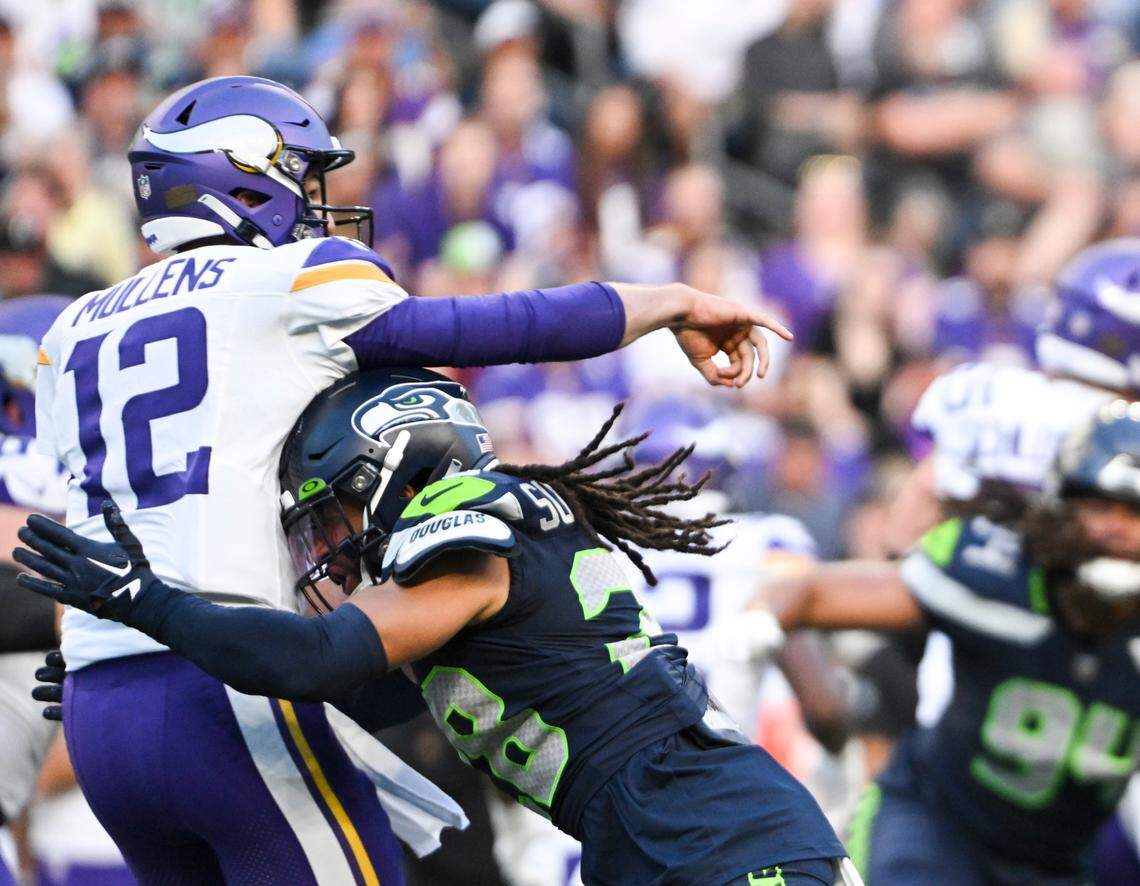 Seattle Seahawks safety Jonathan Sutherland (28) hits Minnesota Vikings quarterback Nick Mullens (12) during the first quarter of the preseason game at Lumen Field, Thursday, Aug. 10, 2023, in Seattle, Wash.