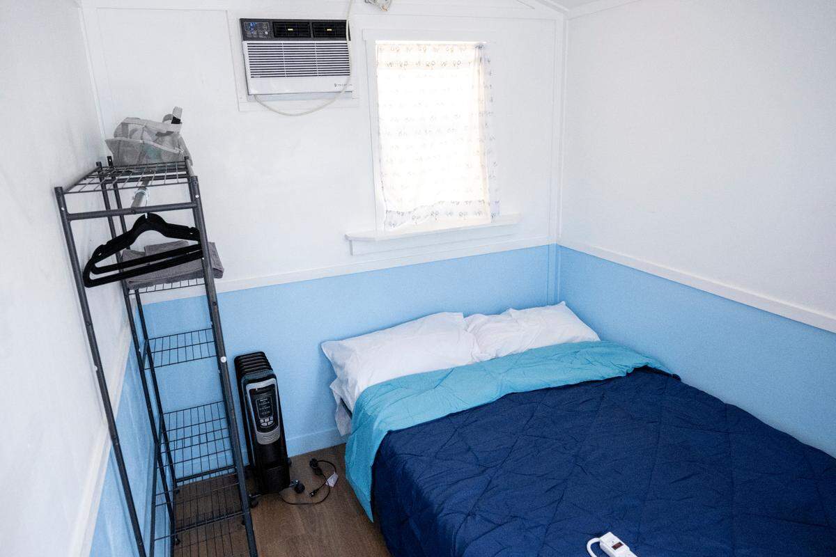 The interior of a tiny home at Kingfisher Village, as well as some of the items supplied to new residents in that space, is pictured on Wednesday, July 23, 2025, in Tacoma.