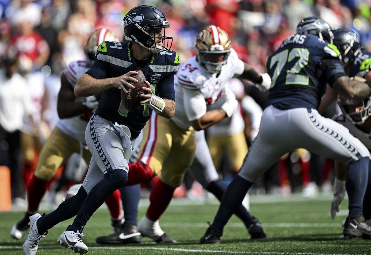 Seattle Seahawks quarterback Sam Darnold (14) scrambles to pass during the third quarter of the game against the San Francisco 49ers at Lumen Field, on Sunday, Sept. 7, 2025, in Seattle.