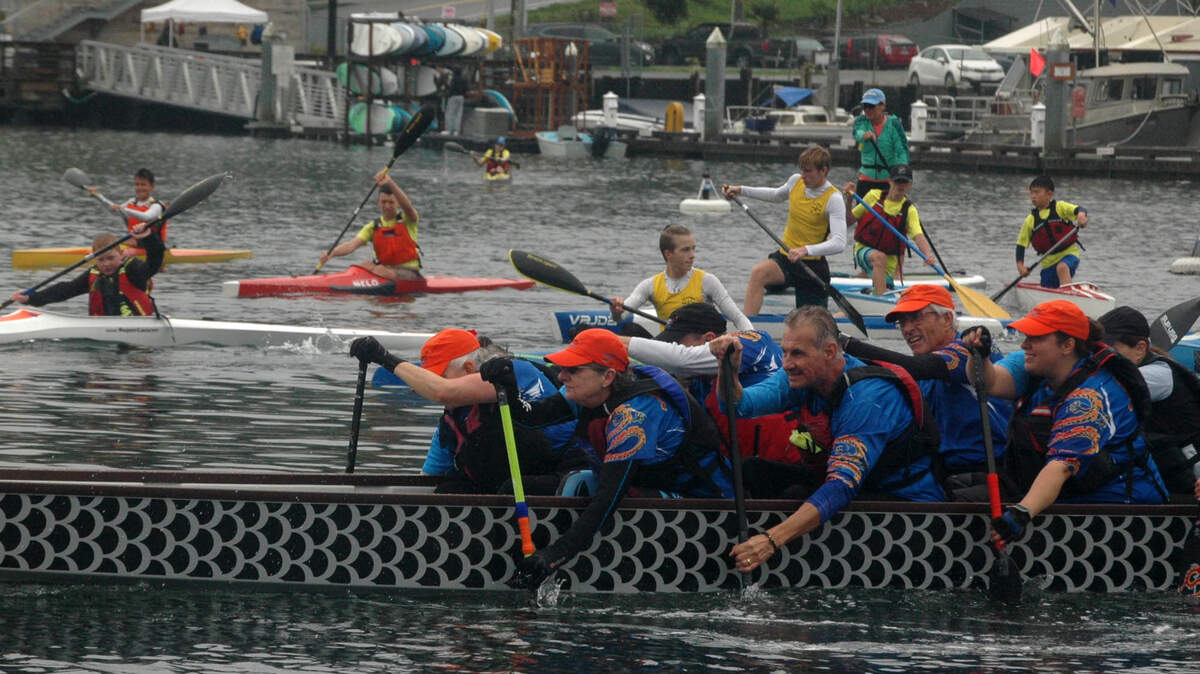 Paddlers aboard the Gig Harbor Dragon boat dug in hard as they joined kayakers and paddleboarders in the traditional parade ending SUP in the Harbor on Sunday. The event raised about $4,000 to support Peninsula schools.