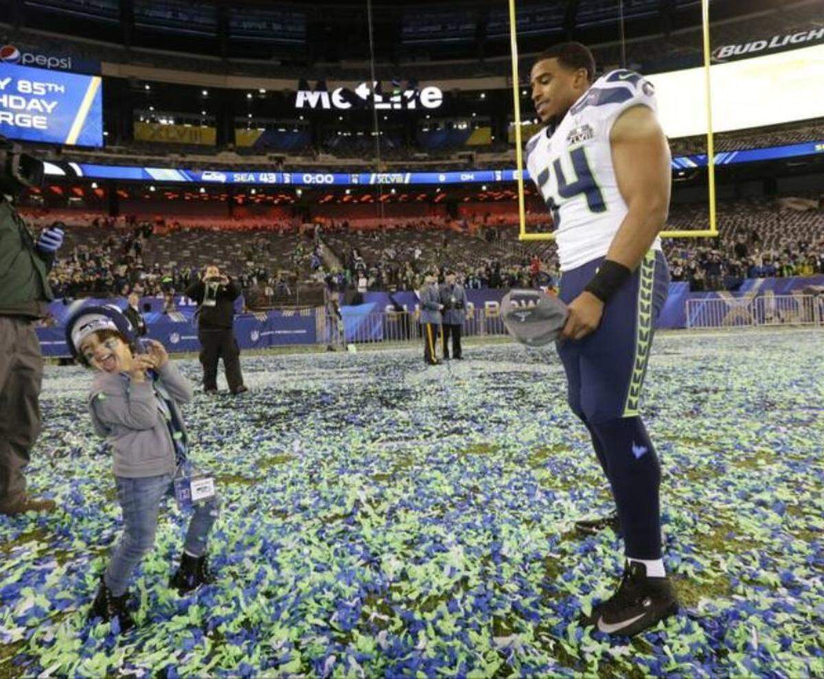Seahawks linebacker Bobby Wagner celebrating with his daughter Quinncy the Seahawks winning Super Bowl 48 over the Denver Broncos in East Rutherford, New Jersey, Feb. 2, 2014.