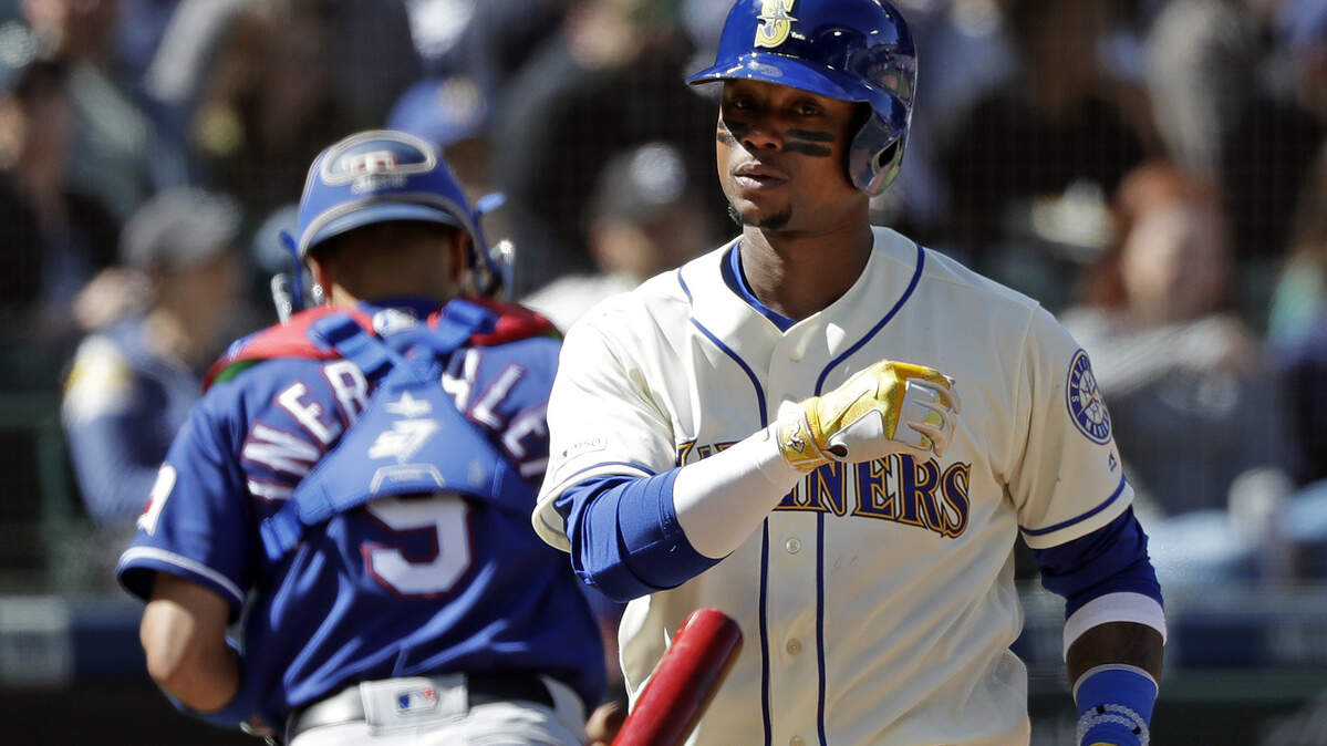 Seattle Mariners’ Tim Beckham tosses aside his bat after striking out to end the sixth inning of a baseball game as Texas Rangers catcher Isiah Kiner-Falefa heads to his dugout Sunday, April 28, 2019, in Seattle.