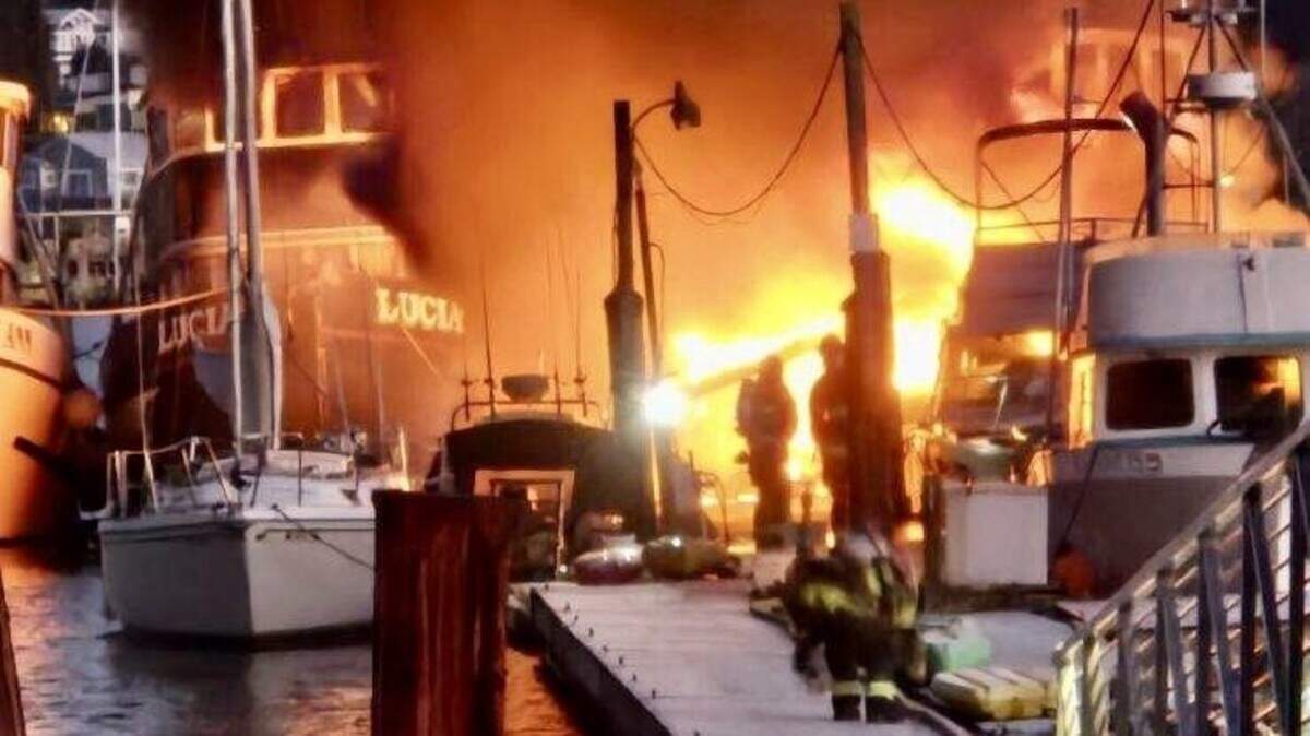 A sailboat sends up flames and smoke Saturday morning at Gig Harbor’s Bujacich Dock.
