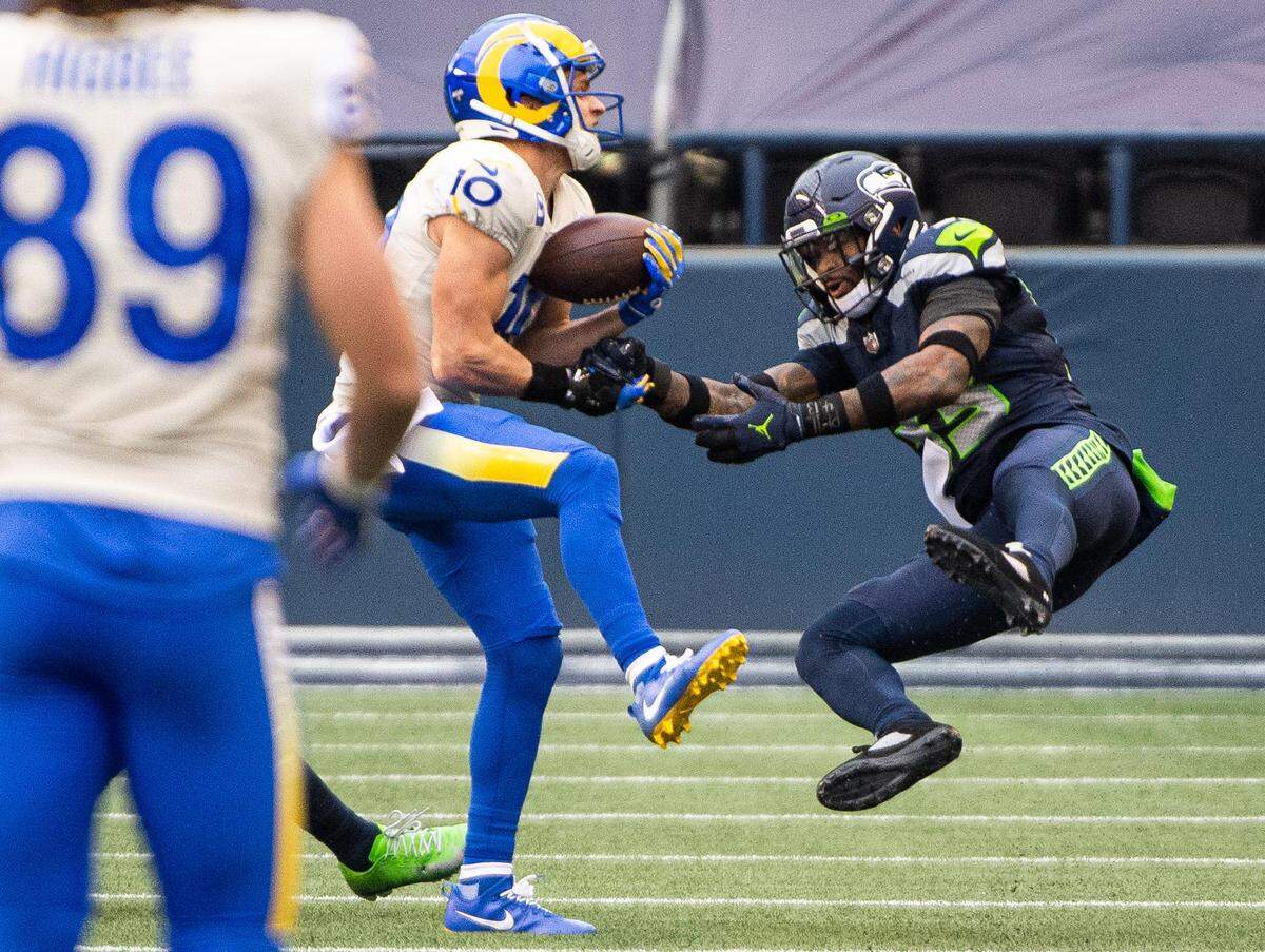 Los Angeles Rams wide receiver Cooper Kupp makes a long catch while defended by Seattle Seahawks defensive back Jamal Adams during the second quarter. The Seattle Seahawks played the Los Angeles Rams in a NFL wildcard playoff game at Lumen Field in Seattle, Wash., on Saturday, Jan. 9, 2021.