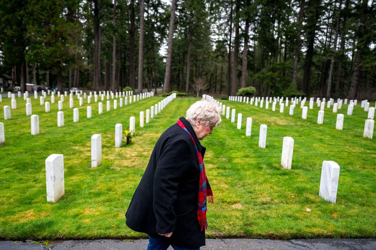 Mary Dowling, of Tenino, walks through the Camp Lewis Cemetery toward her husband’s grave site on Tuesday, Jan. 24, 2023, at Joint Base Lewis McChord.