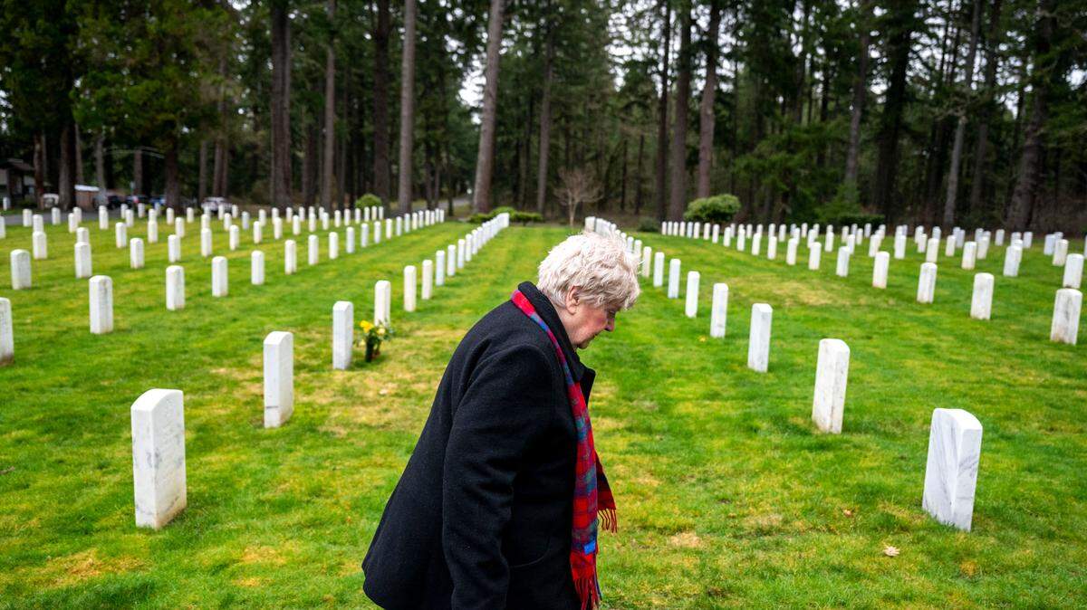 Mary Dowling, of Tenino, walks through the Camp Lewis Cemetery toward her husband’s grave site on Tuesday, Jan. 24, 2023, at Joint Base Lewis McChord.