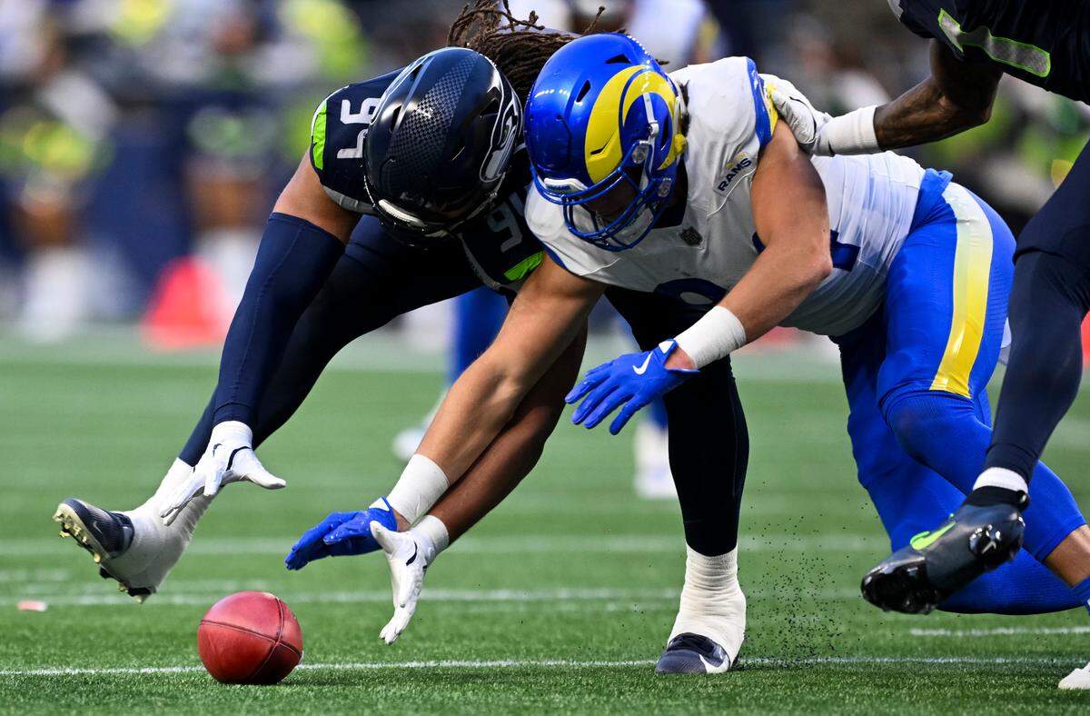 Seattle Seahawks defensive end Mike Morris (94) and Los Angeles Rams tight end Hunter Long (84) dive for the ball after a blocked punt during the fourth quarter of the game at Lumen Field, on Sunday, Nov. 3, 2024 in Seattle, Wash.