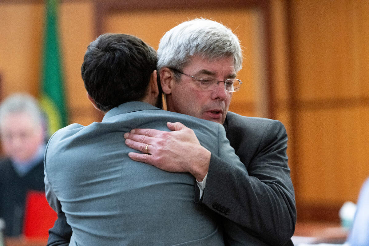 Defendant Christopher Burbank hugs his attorney Wayne Fricke following closing arguments in the the trial of three Tacoma police officers charged in the death in the killing of Manny Ellis.