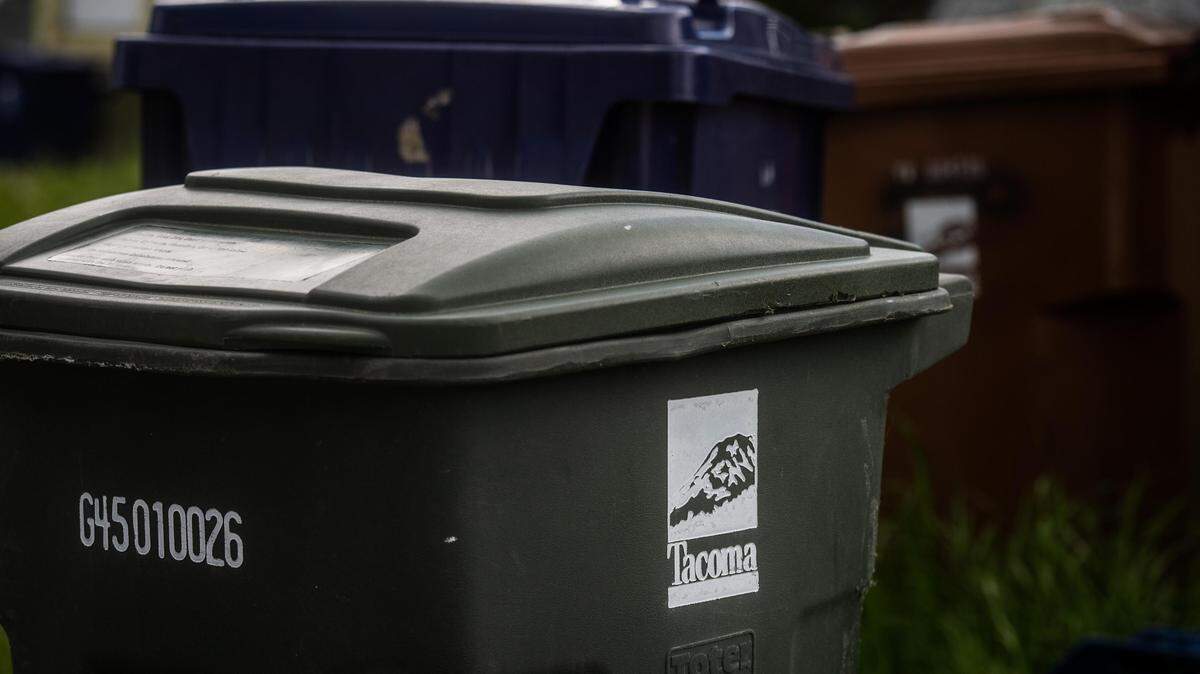 Trash, recycling and yard waste bins are seen in Tacoma, on April 27, 2020.