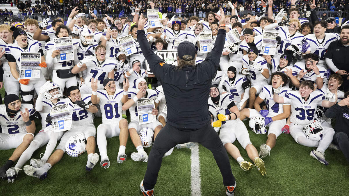 Sumner Spartans head coach Keith Ross and his team celebrate after Sumner’s 41-35 victory against Lake Stevens in the 4A State Championship game at Husky Stadium, on Saturday, Dec. 6, 2025, in Seattle.