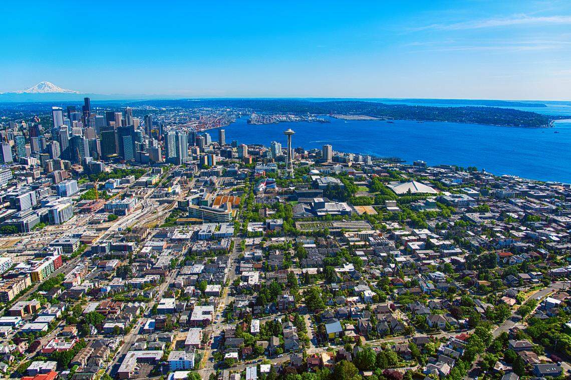 A wide angle aerial view of the downtown skyline and surrounding suburban region of Seattle, Washington. This image was shot from an elevation of approximately 500 feet during a helicopter photo flight.