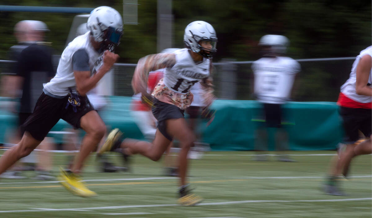 Emerald Ridge wide receivers Denzel Boston (left) and Brandon Snell warm up during football practice at Emerald Ridge High School in Puyallup, Washington, on Thursday, Aug. 19, 2021.