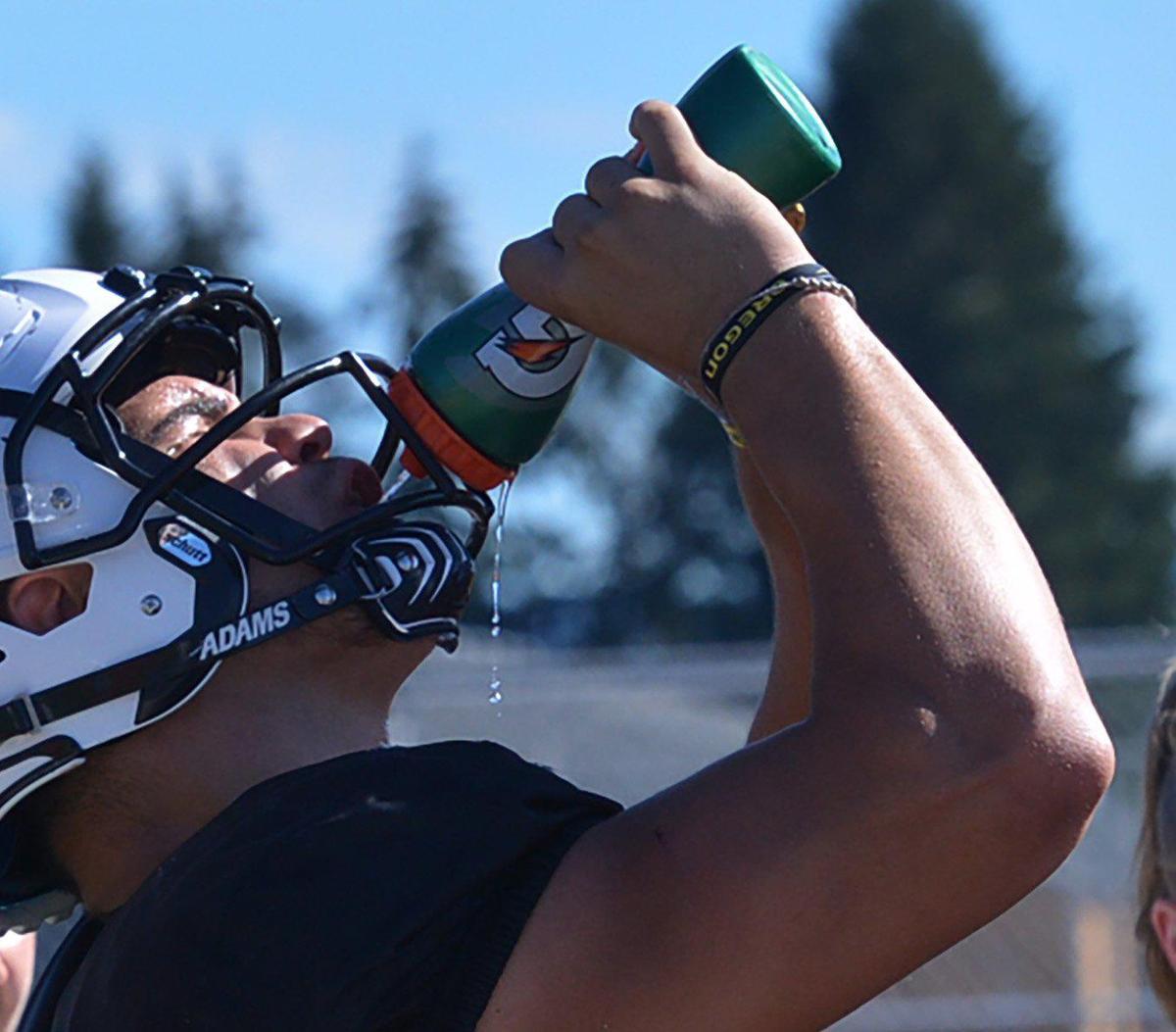 Yelm RB/LB Brayden Platt cools off in plus-90 degree temperatures on Monday, August 22 as the Tornados practice for the 2022 season.