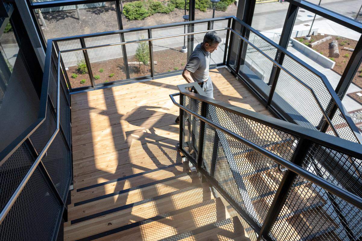 Clay Krauss, executive director of IT, facilities and capital projects, moves between floors of the new Center for Innovative Learning and Engagement at Tacoma Community College on Wednesday, April 23, 2025. The building is LEED gold-certified, which is a measure of how much a building addresses factors like water efficiency, indoor environmental quality and more.