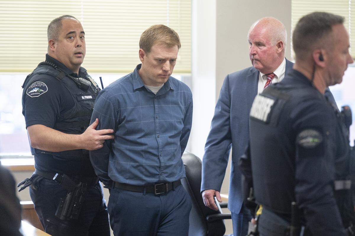 Jordan Henderson, center, is taken into custody after being found guilty of molesting four former Peninsula School District students on Monday, Jan. 5, 2026, at Pierce County Superior Court in Tacoma, Wash. The jury found Henderson guilty on all but one of 13 counts of first-degree child molestation.