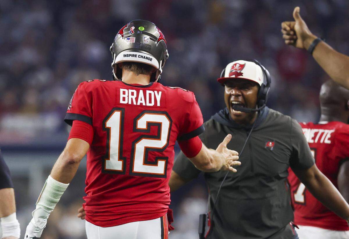 Sep 11, 2022; Arlington, Texas, USA;  Tampa Bay Buccaneers quarterback Tom Brady (12) celebrates with  offensive coordinator Byron Leftwich after throwing a touchdown  pass during the second half at AT&T Stadium. Mandatory Credit: Kevin Jairaj-USA TODAY Sports