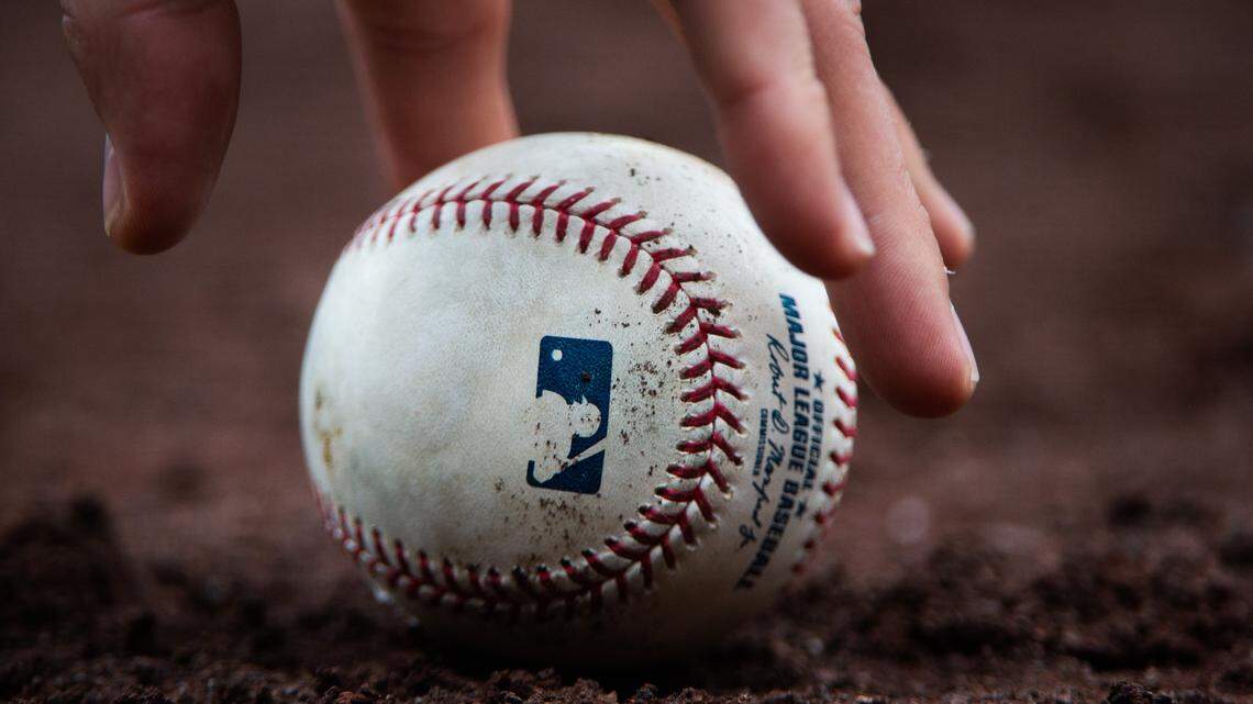 A baseball is picked up during the game. The Seattle Mariners played the Houston Astros in a Major League Baseball game at T-Mobile Park in Seattle, Wash., on Sunday, April 14, 2019.