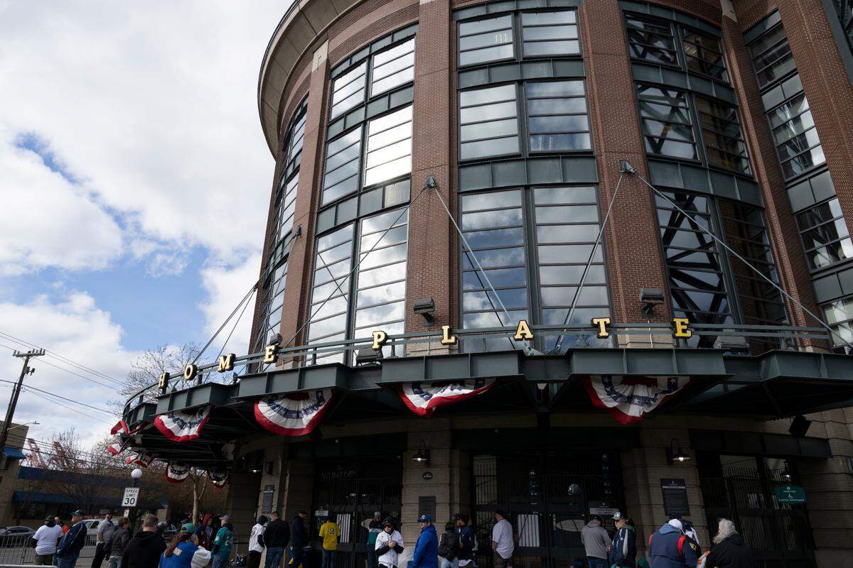 Fans line up at the gates before the opening day game between the Boston Red Sox and Seattle Mariners at T-Mobile Park, on Thursday, March 28, 2024, in Seattle, Wash.
