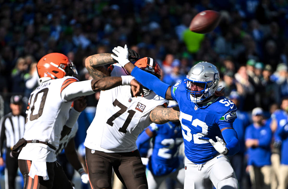 Seattle Seahawks linebacker Darrell Taylor (52) pressures Cleveland Browns quarterback PJ Walker (10) as he throws during the first quarter of the game at Lumen Field, Sunday, Oct. 29, 2023, in Seattle, Wash.