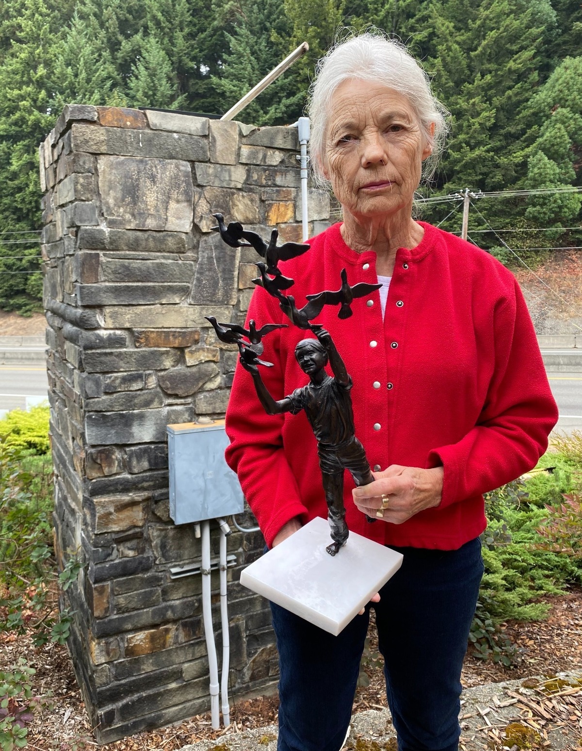 Sherilyn Anderson holds a maquette of the stolen statue Thursday morning.