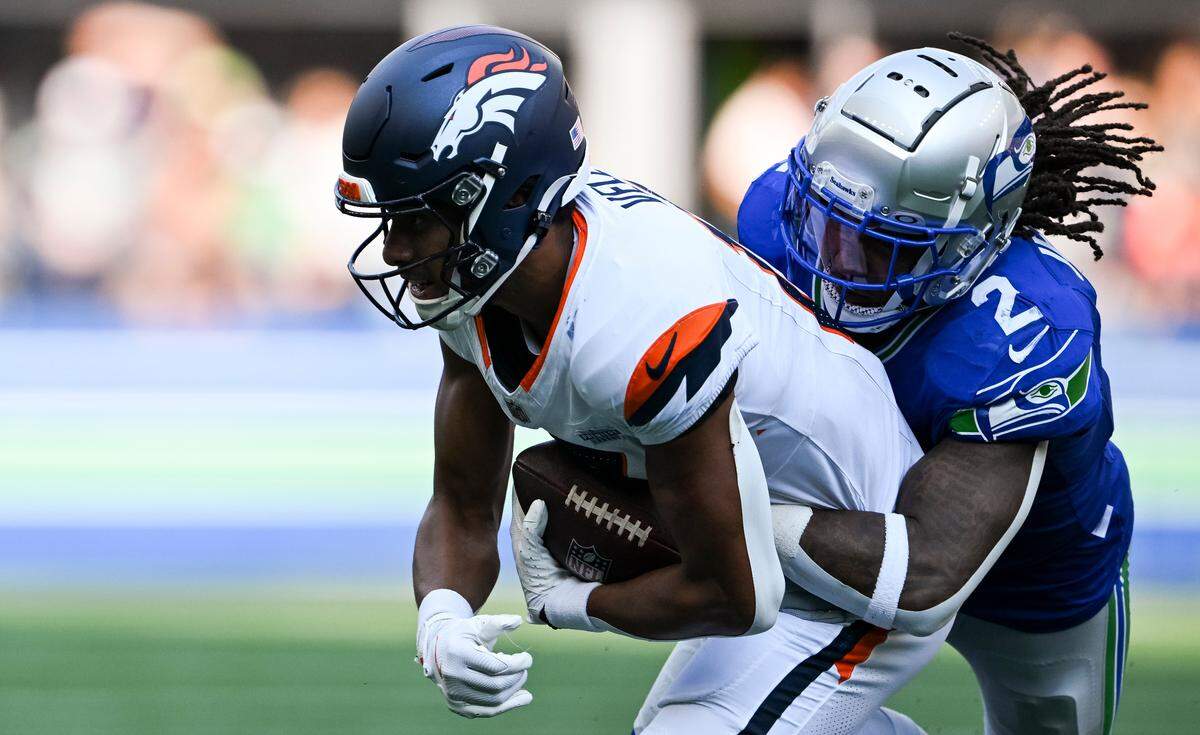 Seattle Seahawks safety Rayshawn Jenkins (2) tackles Denver Broncos wide receiver Devaughn Vele (17) during the third quarter of the game at Lumen Field, on Sunday, Sept. 8, 2024, in Seattle, Wash.