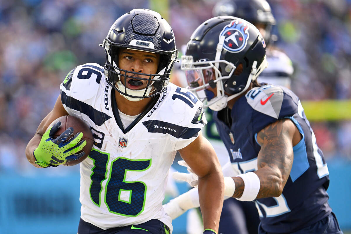 Seattle Seahawks wide receiver Tyler Lockett (16) runs against Tennessee Titans cornerback Tre Avery during the second half of an NFL football game on Sunday, Dec. 24, 2023, in Nashville, Tenn. (AP Photo/John Amis)