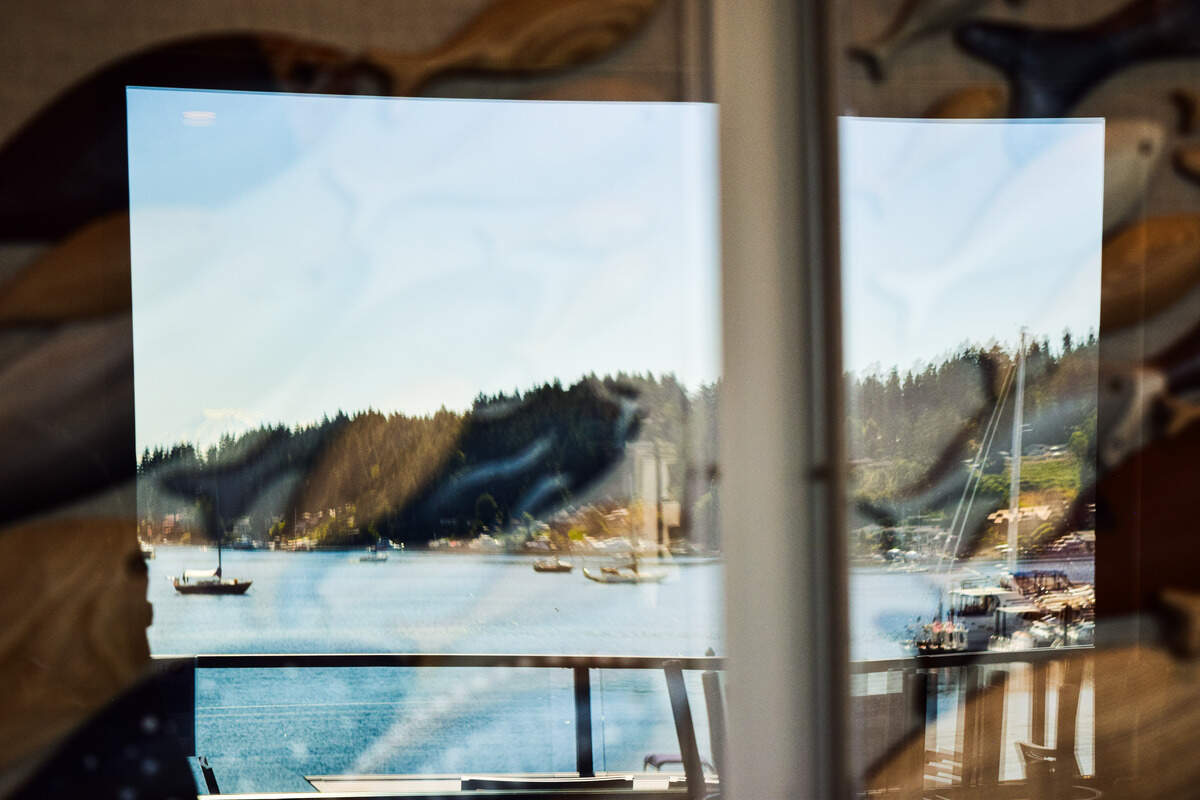 The Denglers invited staff to their house during the renovations to paint wooden fish, now commemorated in the center of the dining room, reflecting the waterfront views.