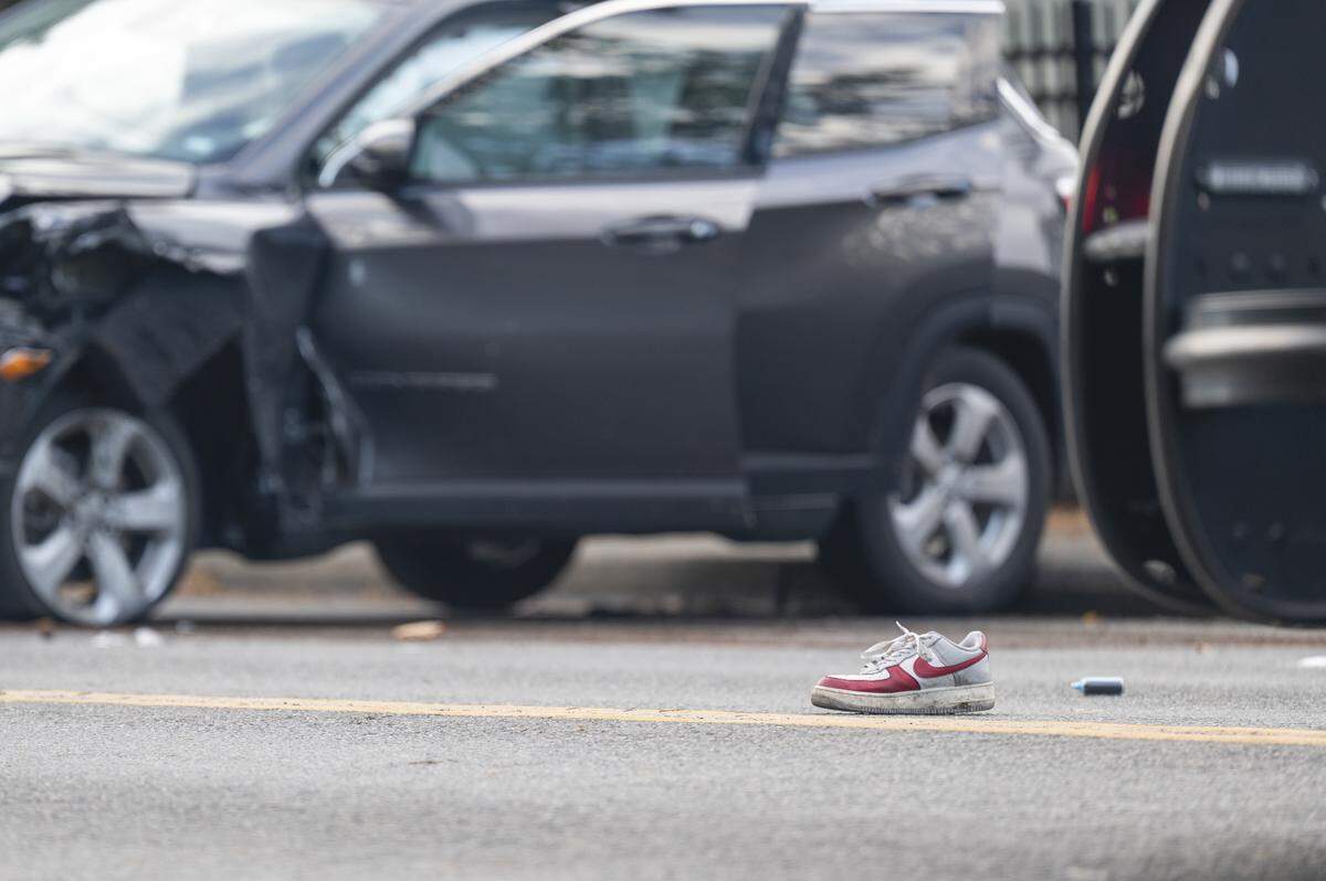 A shoe sits in the middle of 96th Street South after a driver struck a pedestrian and another vehicle on 96th Street South on Monday, Nov. 10, 2025, in Tacoma, Wash. Initial reporting of the crash on Monday reported two people, one on a bicycle and another on a skateboard, were struck.