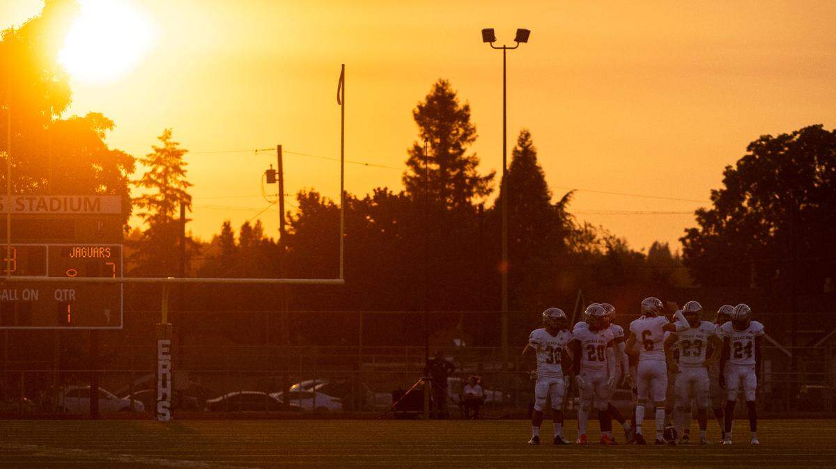 Emerald Ridge players prepare to resume the game after a timeout during the season opener game at Sparks Stadium in Puyallup Wash. on Sept. 2, 2022.
