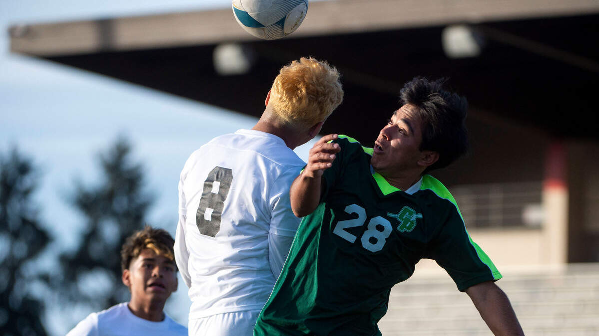 Clover Park’s Antonio Velasquez fights for a header in the penalty box with Othello’s Isaac Rodriguez during the second half of a State 2A first-round tournament game on Tuesday, May 17, 2022, at Harry Lang Stadium in Lakewood, Wash.