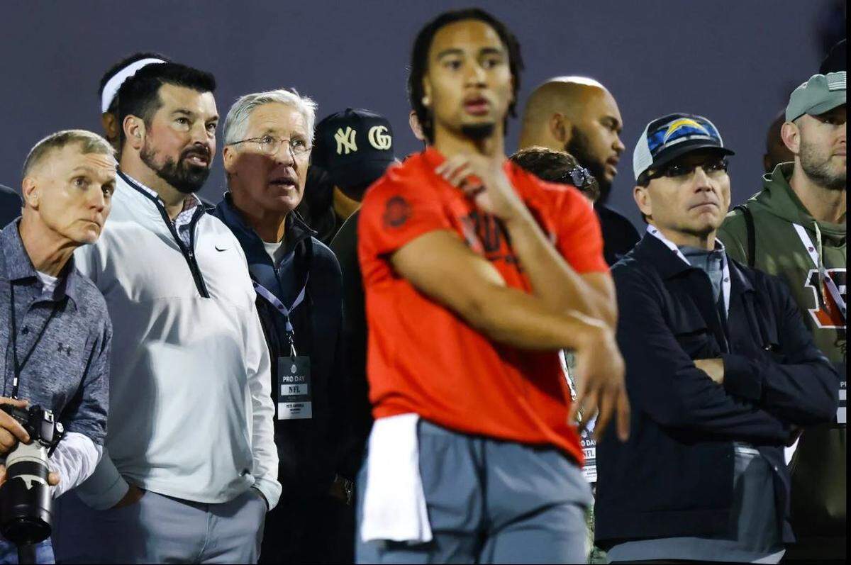 Seahawks coach Pete Carroll, third from left, and Ohio State coach Ryan Day, second from left, among the NFL scouts watching departing Buckeyes quarterback C.J. Stroud throw at OSU’s Pro Day in Columbus, Ohio, March 22, 2023.