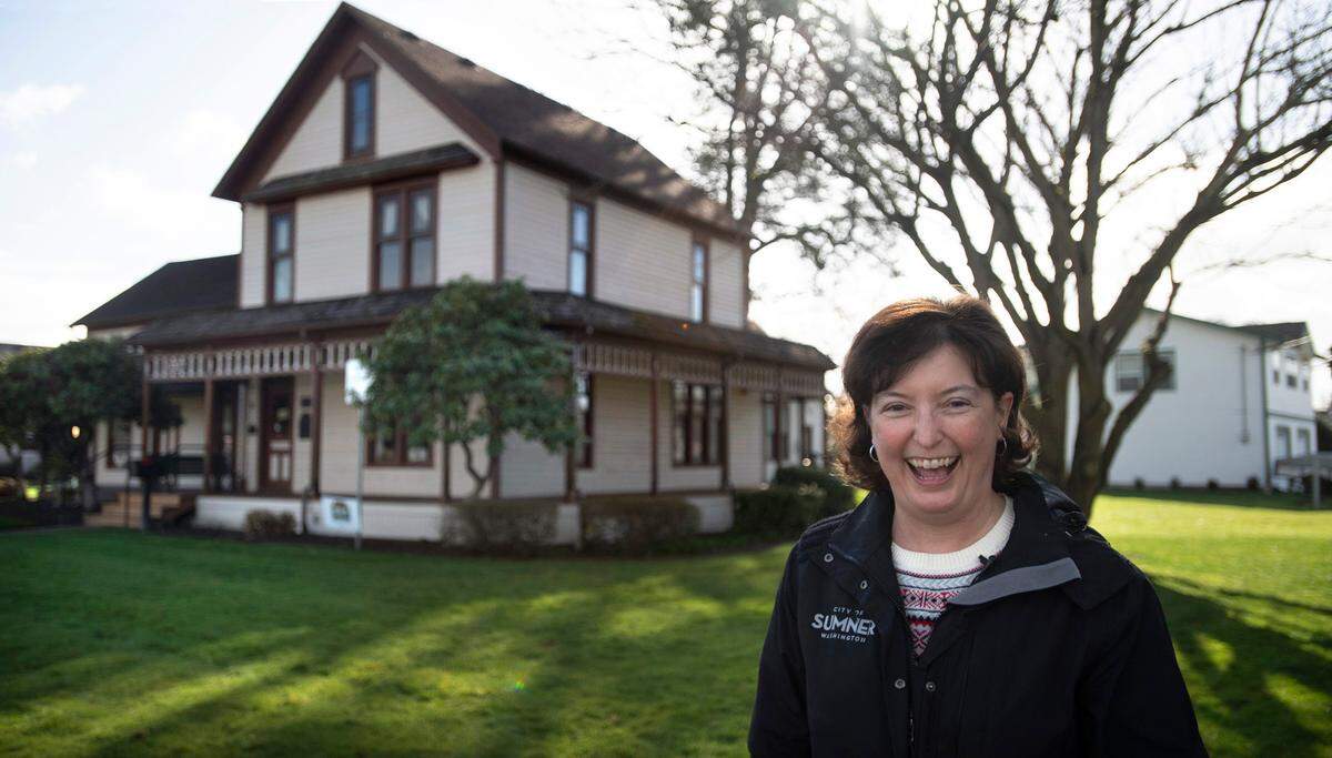 City of Sumner spokesperson Carmen Palmer in front of the Sumner Ryan House Museum at Lucy V. Ryan Park in downtown Sumner, Washington, on Wednesday, Feb. 16, 2022. The city is planning to renovate the historic home and public park to encourage visitors to what many people think is a private residence, she said.
