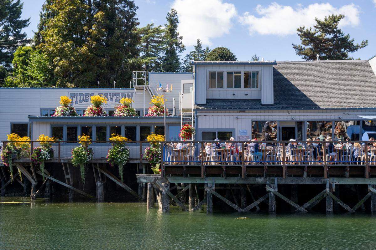 The deck is full of people enjoying lunch and the Friday sunshine at Tides Tavern in Gig Harbor, on Sept. 8, 2023.