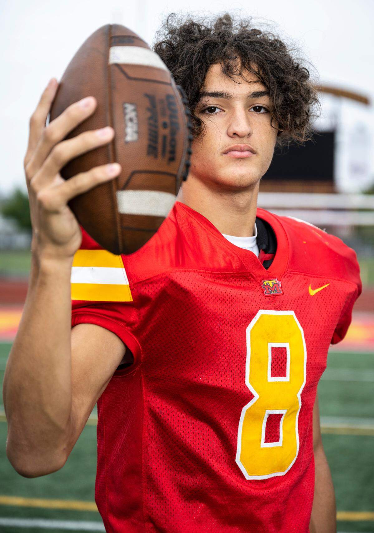 Mount Tahoma varsity football quarterback Derrik McKinney poses for a portrait on the field at Mount Tahoma High School in Tacoma, Wash. on Oct. 5, 2022.