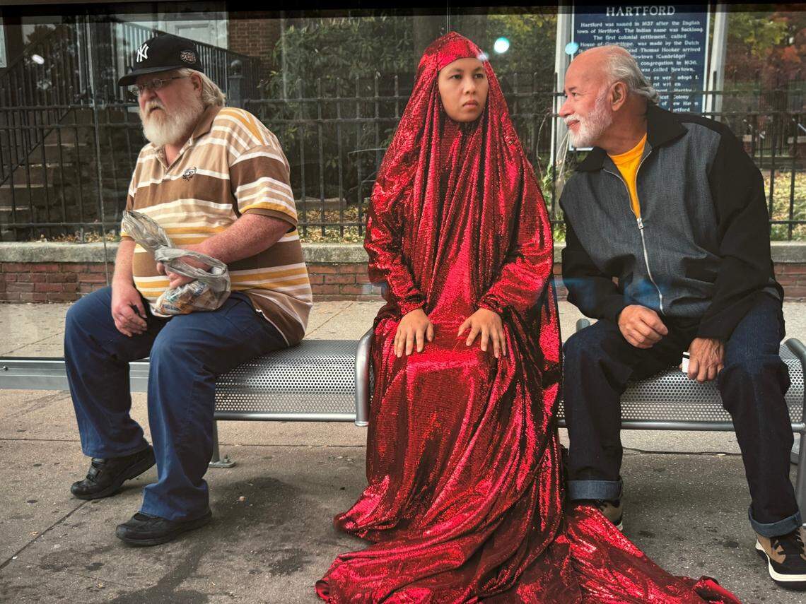 Anida Yoeu Ali wears the Red Chador in one of the many photographs in her show at Seattle Asian Art Museum.
