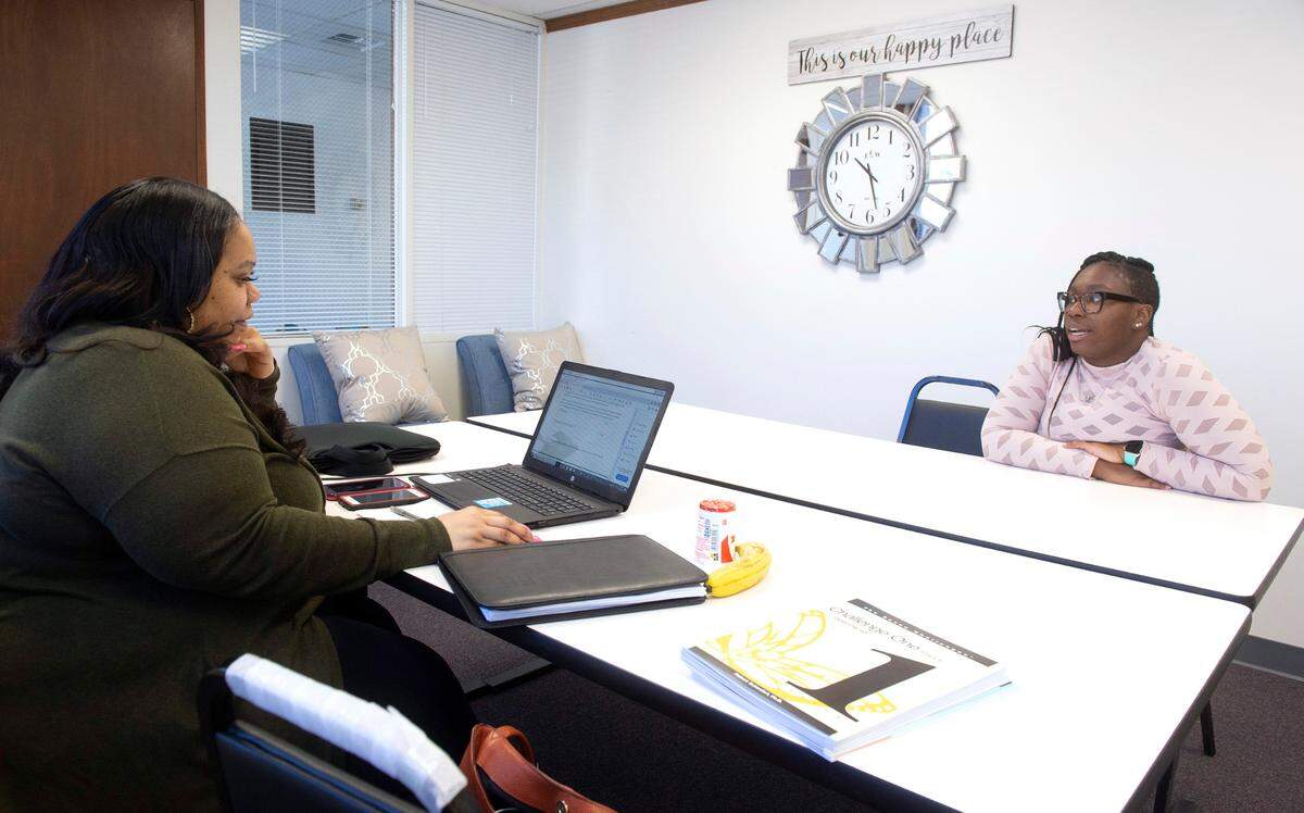 Kisela Canada (left) and Shundra King discuss client treatment scheduling at their For The Culture Counseling Services office in Tacoma, Washington, on Wednesday, April 21, 2021.