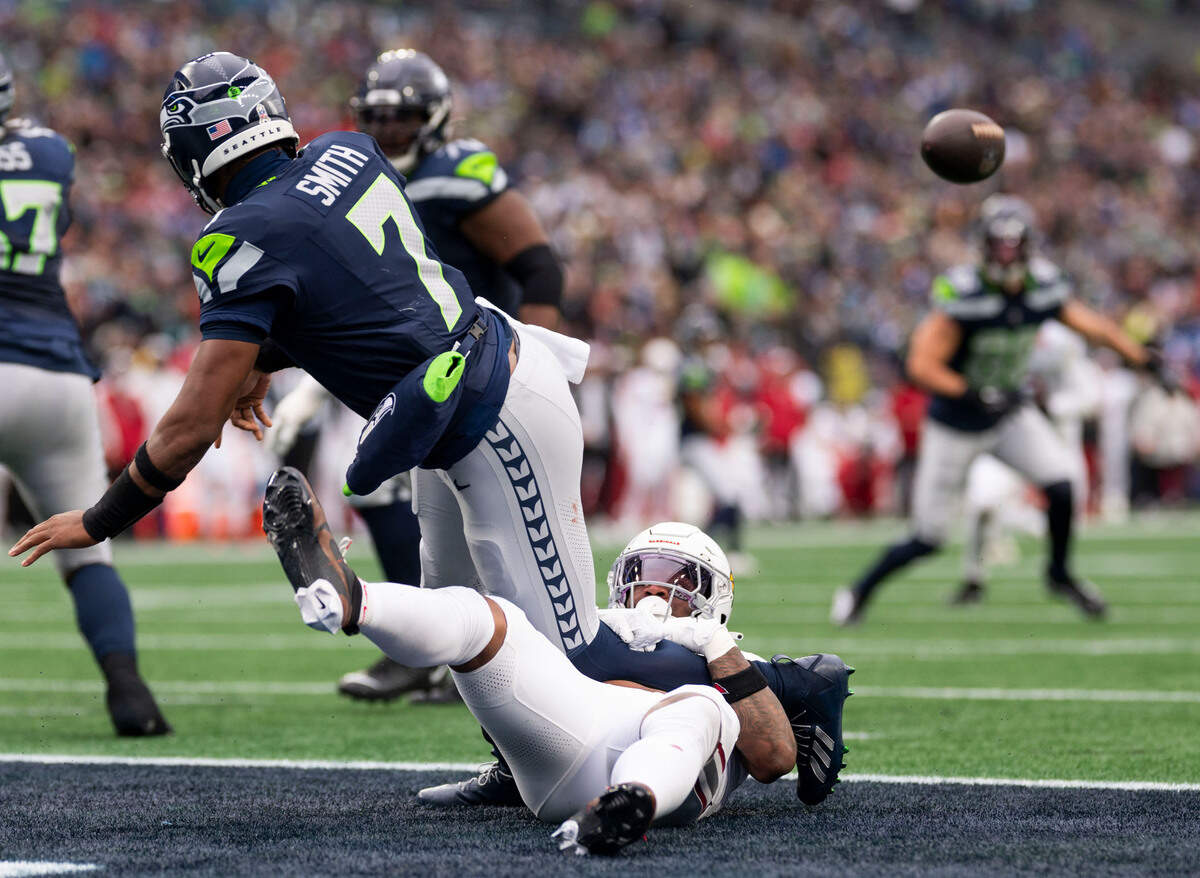 Arizona Cardinals linebacker Mack Wilson Sr. (2) forces Seattle Seahawks quarterback Geno Smith (7) to throws the ball away in the end zone during the second quarter of the game at Lumen Field, on Sunday, Nov. 24, 2024, in Seattle, Wash.