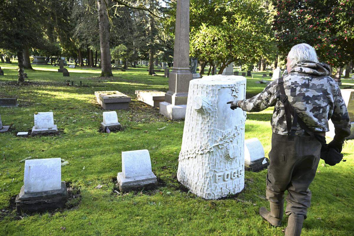 William Fleet points out details of headstones he has cleaned in the last several years at the old Tacoma Cemetery on Monday, March 9, 2026, in Tacoma, Wash.