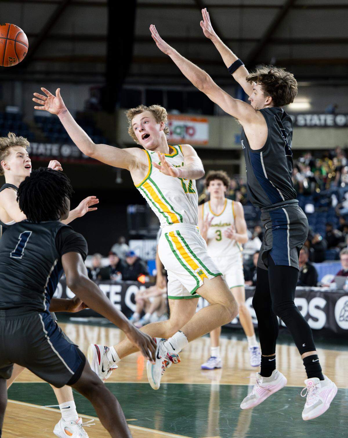 Richland’s Joshua Woodard (12) passes the ball during the semifinals game of the Class 4A state tournament at the Tacoma Dome, on Friday, March 1, 2024, in Tacoma, Wash.