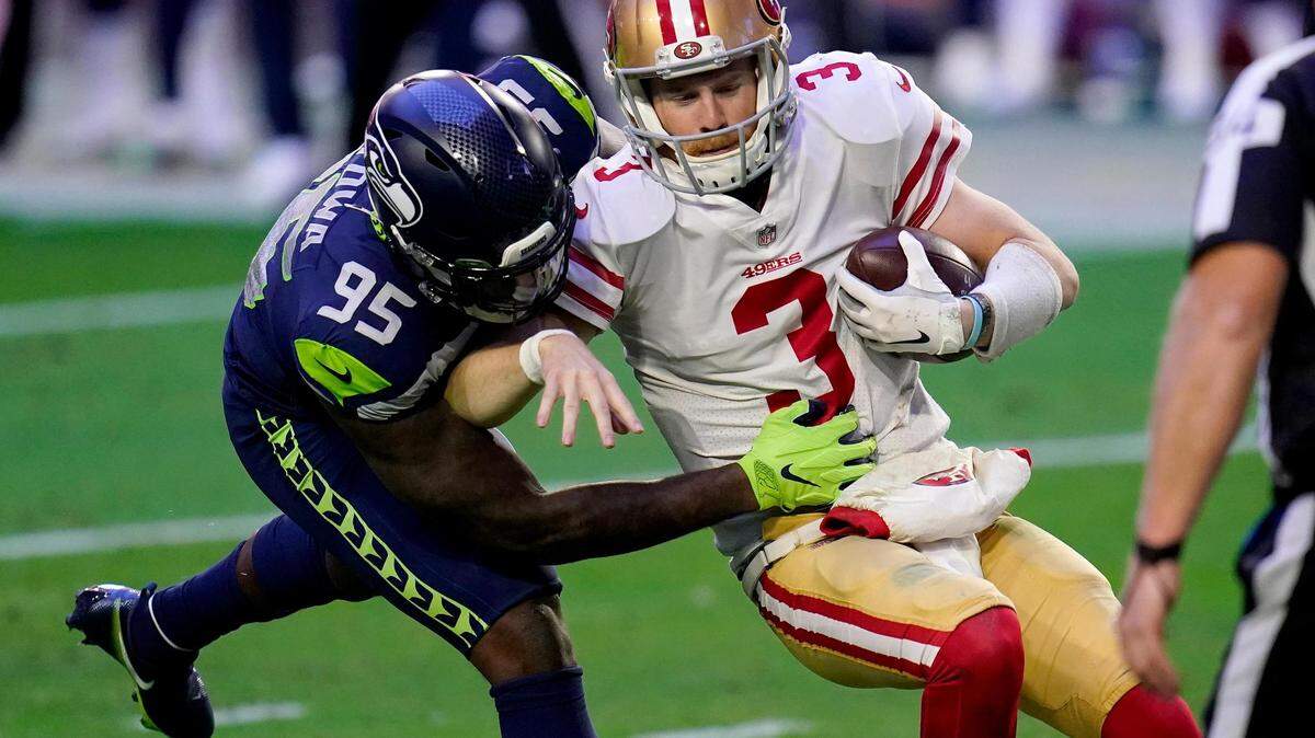 San Francisco 49ers quarterback C.J. Beathard (3) is sacked by Seattle Seahawks defensive end Benson Mayowa (95) during the first half of an NFL football game, Sunday, Jan. 3, 2021, in Glendale, Ariz. (AP Photo/Ross D. Franklin)