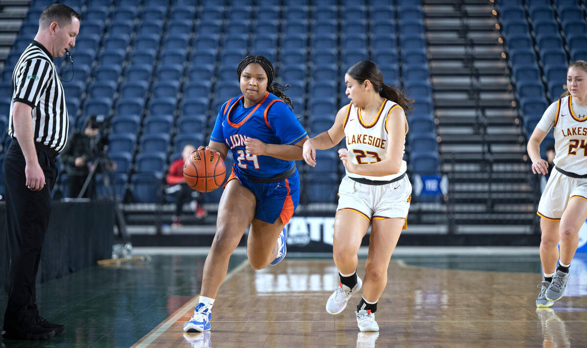 Auburn Mountainview’s Kyra Thomas pushes the ball up court alongside Lakeside defender Kayla Garmoe during the opening day of the WIAA State Basketball tournament in the Tacoma Dome in Tacoma, Washington, on Wednesday, March 1, 2023. Lakeside won the game, 47-27.