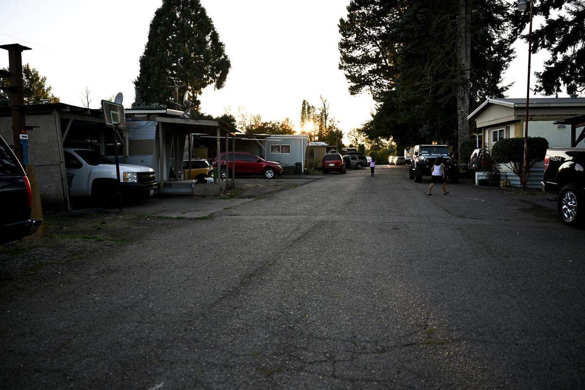 Children play as the sun sets at Cottonwood Mobile Home Park, Wednesday, Sept. 13, 2023, outside Puyallup, Wash. Shortly after Hurst & Son LLC purchased the mobile home park residents started receiving door hangers notifying them of a near 50% rent hike and new fees. The price hike has forced some to leave.