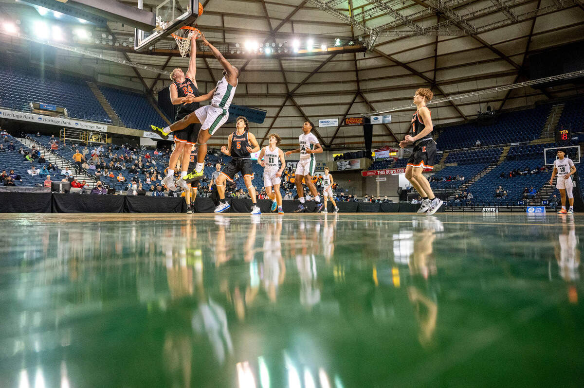 Auburn guard Luvens Valcin (5) attempts a shot as Kennewick forward Ayden Knapik (24) defends during the third quarter of a Class 3A state tournament game on Wednesday, March 2, 2022, at the Tacoma Dome, in Tacoma, Wash.