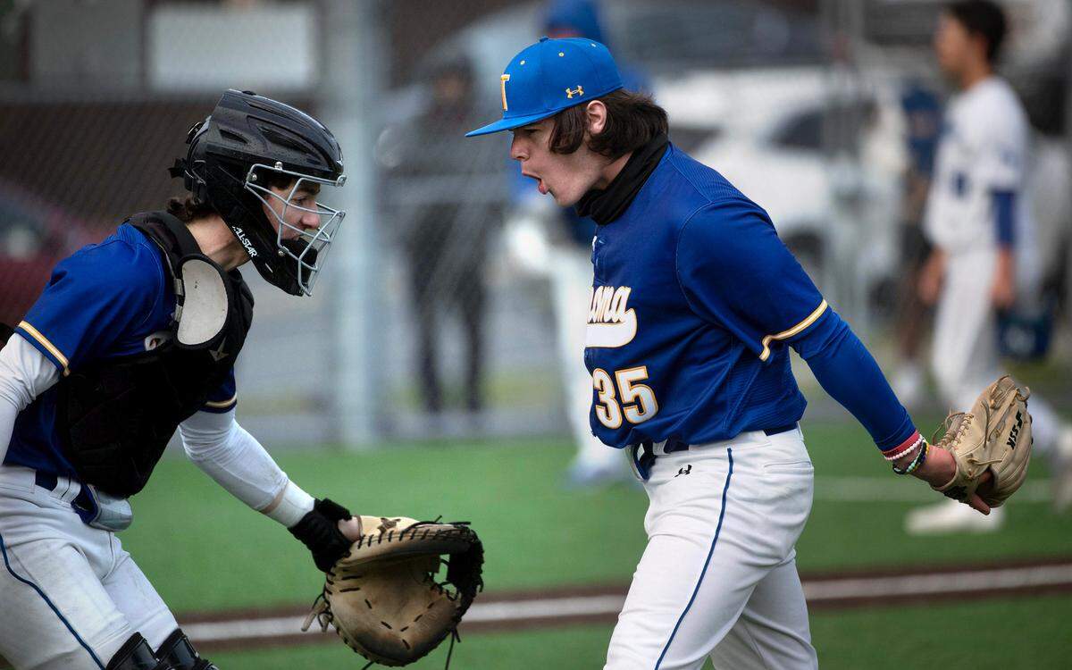 Tahoma catcher Carson Ohland and closing pitcher Jackson Walker celebrate the final out in the Bear’s 4-2 victory over the Federal Way Eagles in Tuesday afternoon’s baseball game at Federal Way High School in Federal Way, Washington, on Tuesday, April 18, 2023.